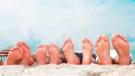 Young couples feet at the beach